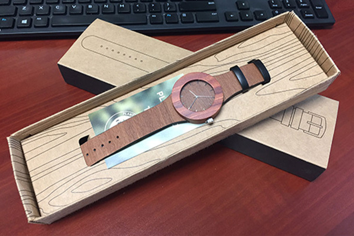 Makore & Red Sanders wristwatch in box on a computer desk