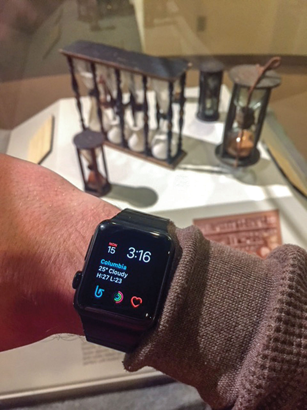 First Generation Apple Watch with hourglasses in background at the National Watch & Clock Museum.
