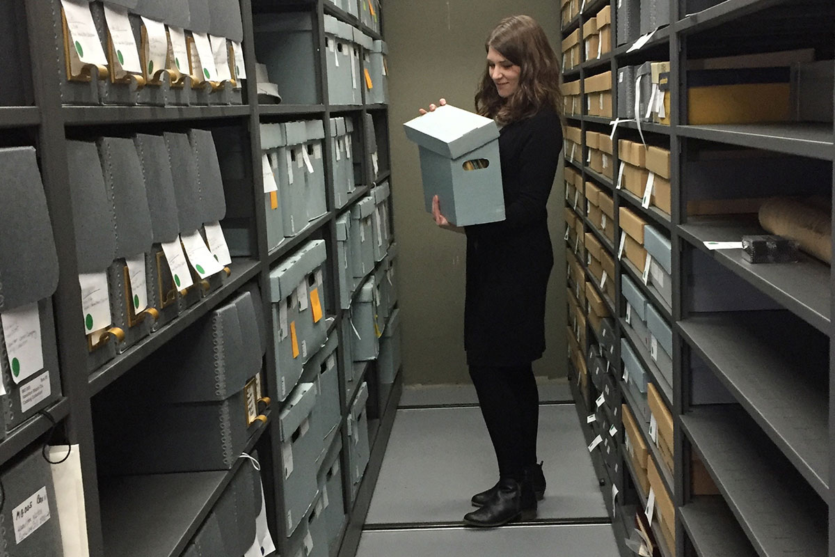 Ms. Moclock looking a box of Hamilton Watch Company documents in the Fortunat Mueller-Maerki Library and Research Center Archives.
