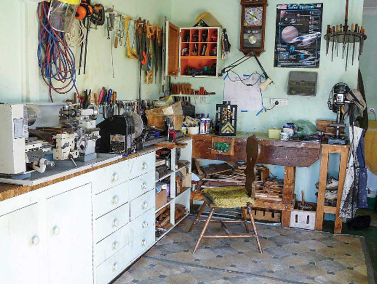 An orderly workshop with many tools and several work shelves
