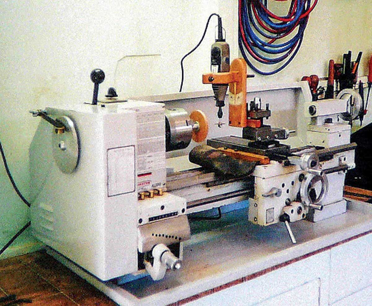 A white modern electric wheel cutting machine roughly the size of a sewing machine