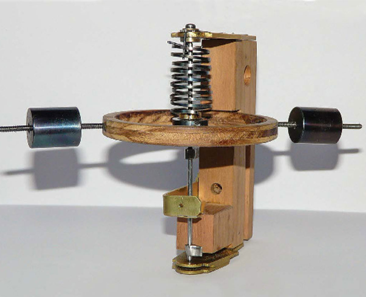 A wooden balance wheel with metal springs and timing weights