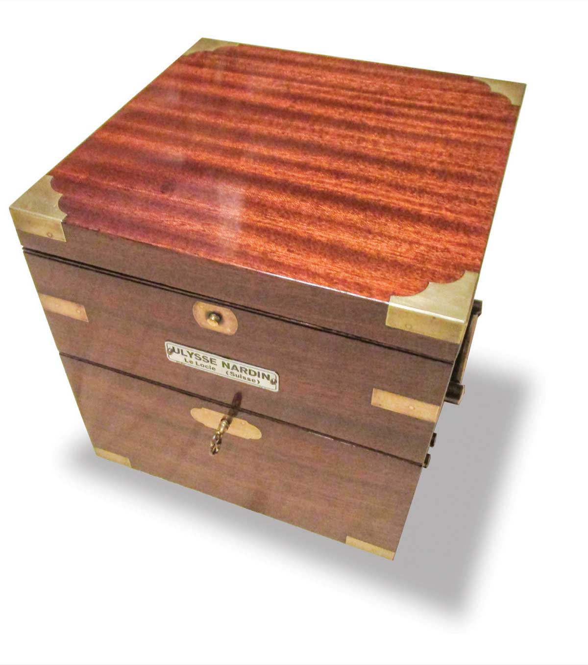A 3-tier box made of ribbon-cut Honduran mahogany with brass-bound accents, nameplate, and drop handles